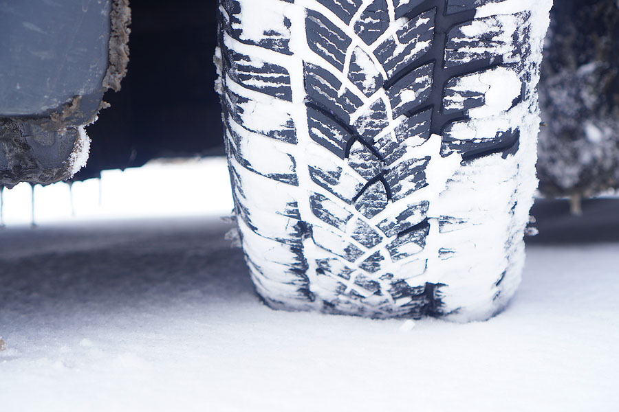 close up of snow-covered car tire